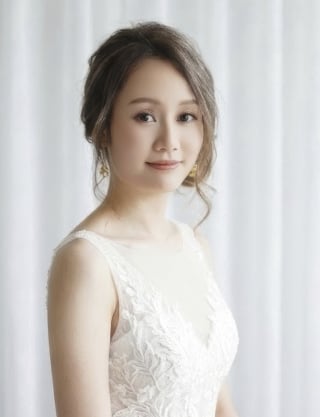 59-Bridal-low-bun-with-subtle-braiding-details-integrated-into-dark-hair